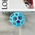 Light blue geometric dog chew ball with a metallic pink inner bell 
