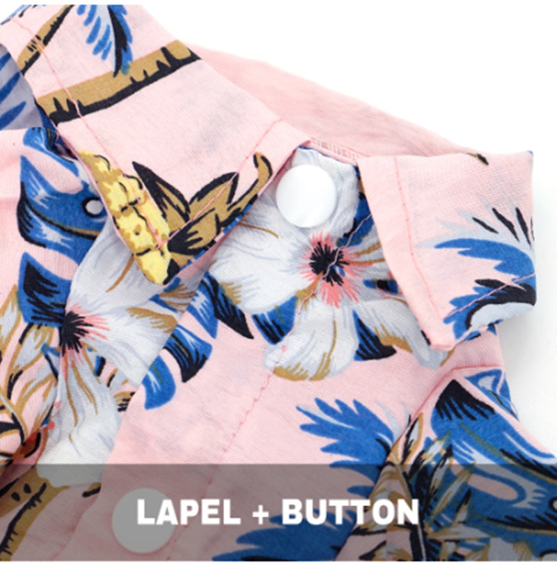 Close‑up of a pet shirt collar and button showing a pink floral tropical pattern.