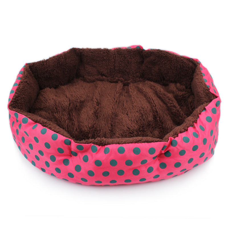 Pet bed with pink and green polka dot exterior and brown interior on a white background