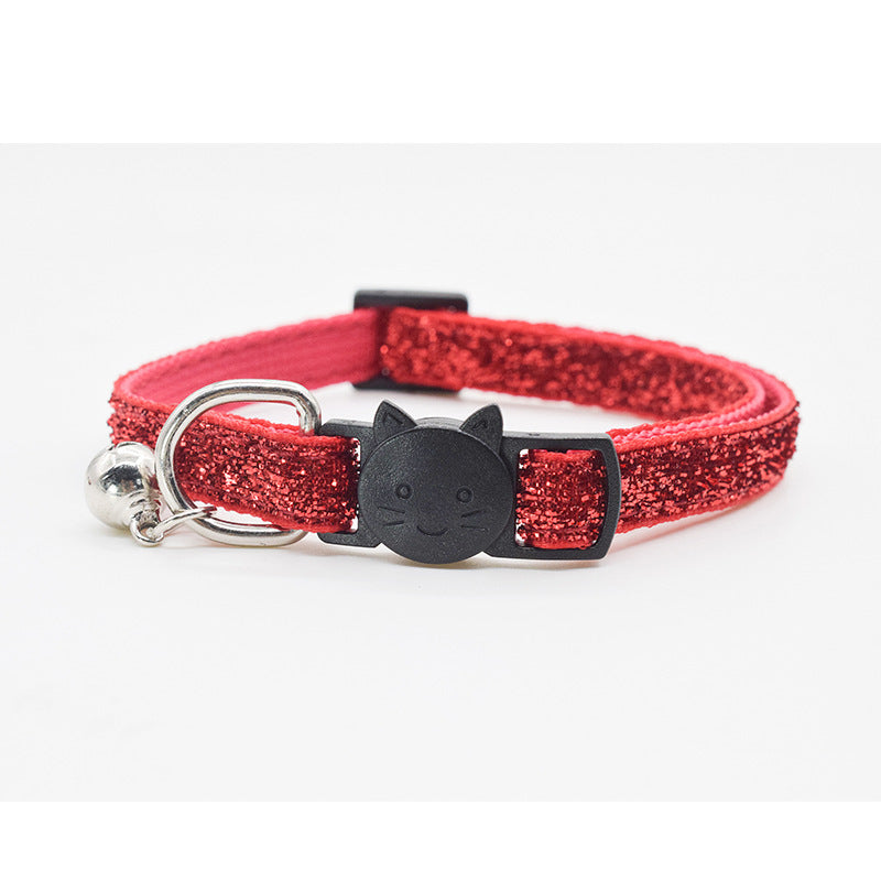 Red glittery cat collar with a black cat-shaped buckle on a white background