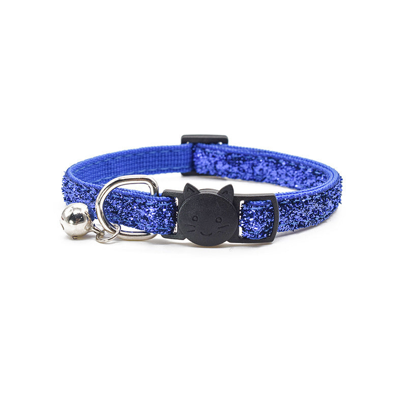 Blue glittery cat collar with a bell and black cat-shaped tag on a white background