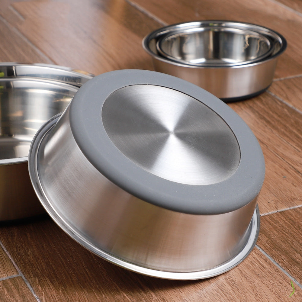 Stainless steel pet bowls with gray lids on a wooden floor
