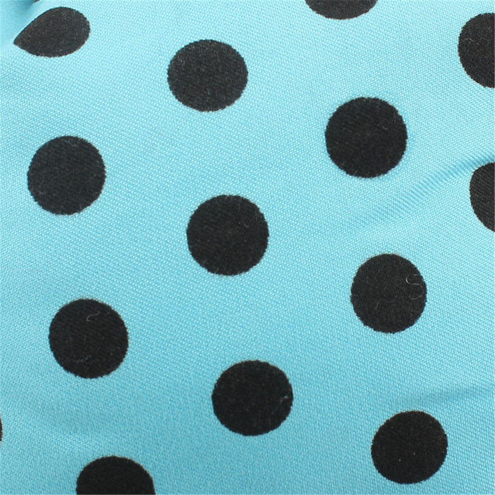 Close-up of blue fabric with black polka dots