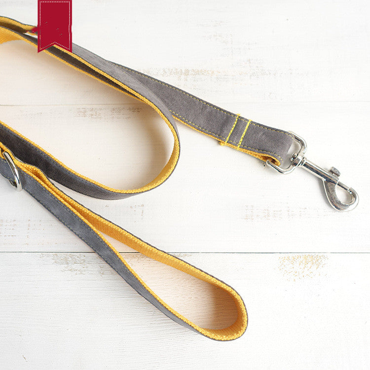 Gray and yellow dog leash on a light wooden surface