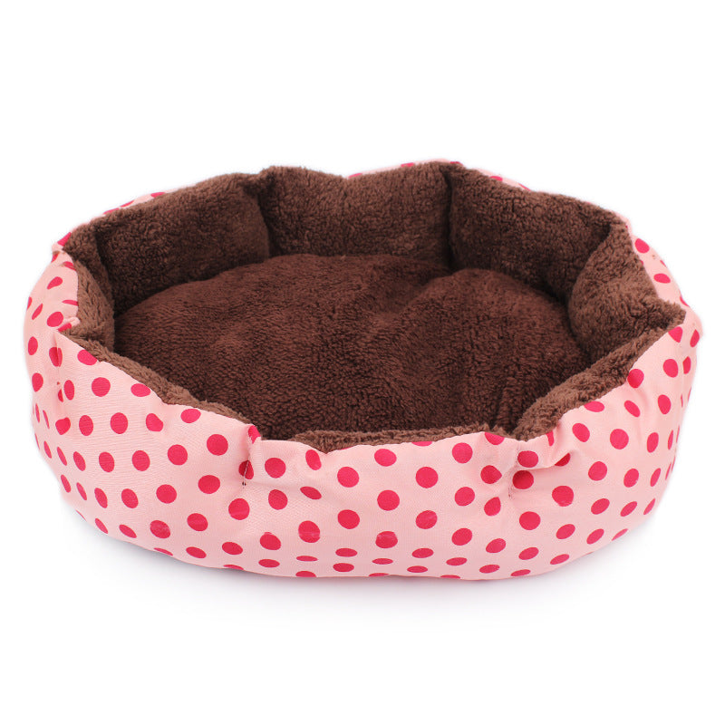 Pet bed with pink polka dot exterior and brown interior on a white background
