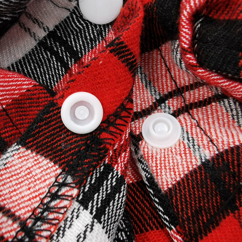 Close-up of red, black, and white plaid fabric with white buttons.