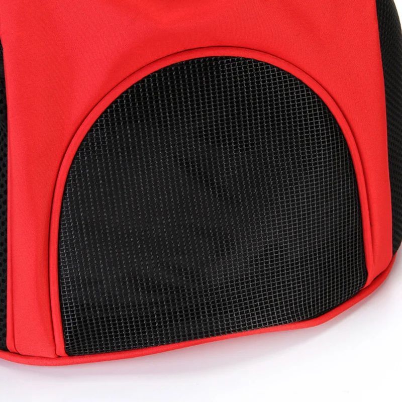 Red pet carrier with black mesh side on a white background
