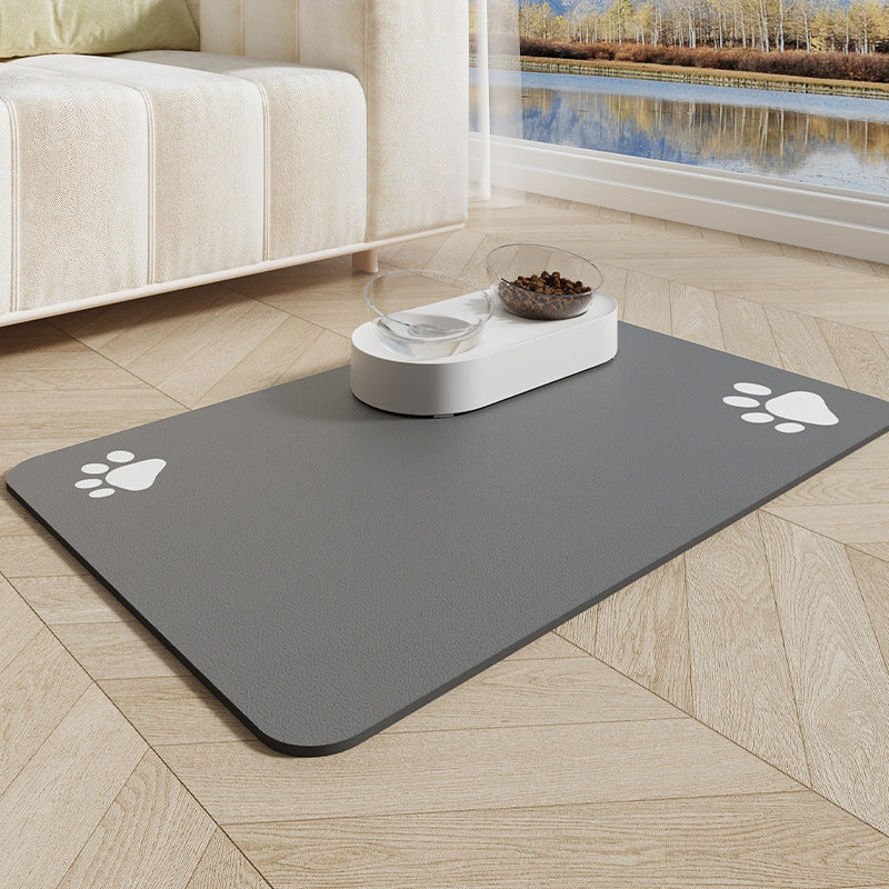 Gray pet mat with paw prints on a wooden floor in a living room.