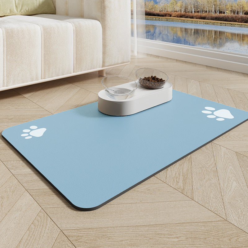 Pet mat with paw prints on a wooden floor in a room with a couch and window view.