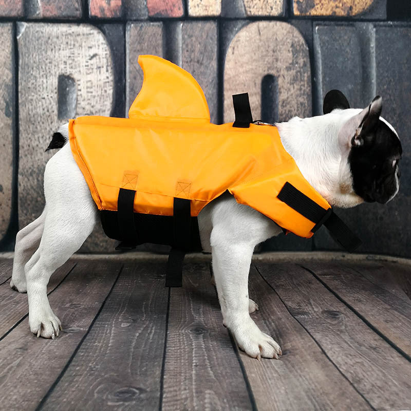 Side view of dog life vest with shark design in orange