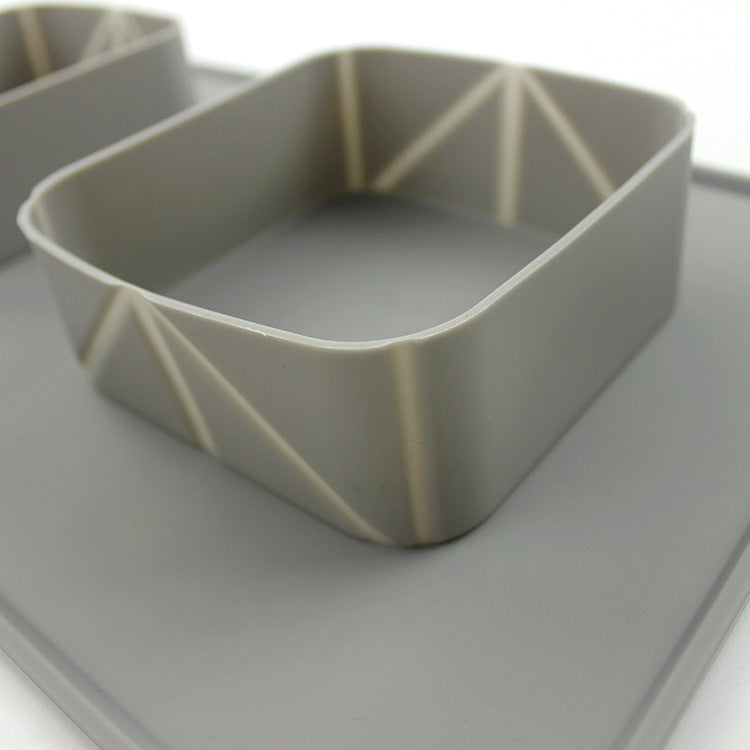 Gray silicone collapsible pet bowl with reinforced sides placed on a flat surface.