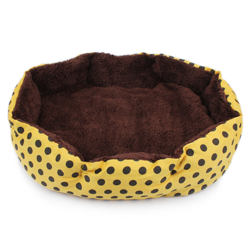 Pet bed with brown interior and yellow exterior with black polka dots on a white background