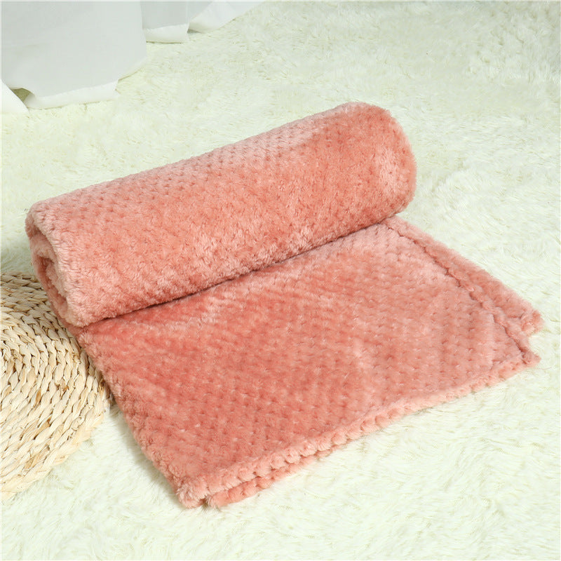 Pink textured blanket on a light surface