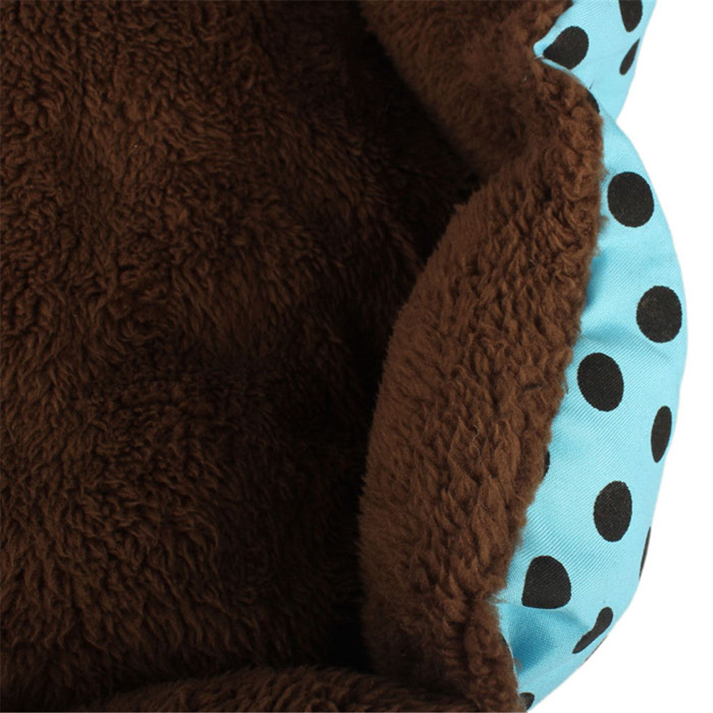 Close-up of a brown textured fabric with a blue and black polka dot border.