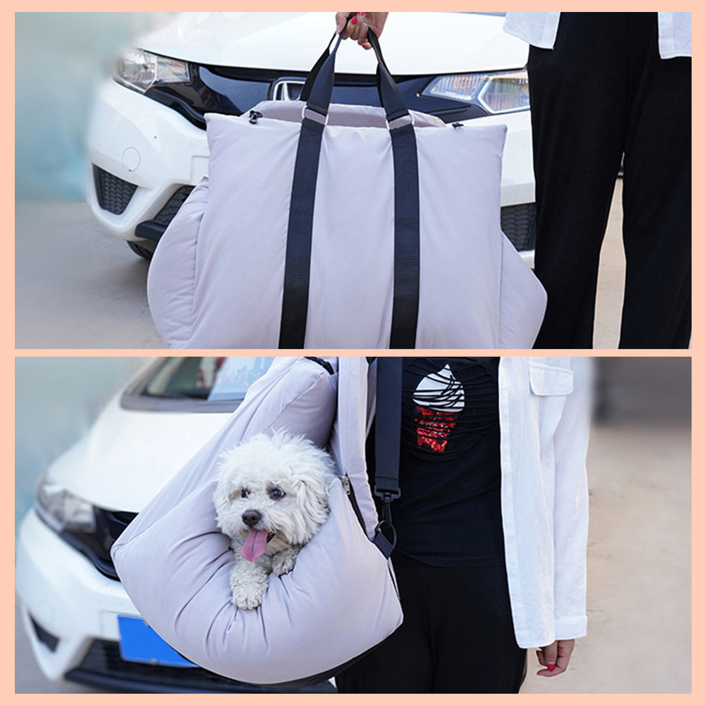 Pet carrier being used to transport a small white dog in front of a car.