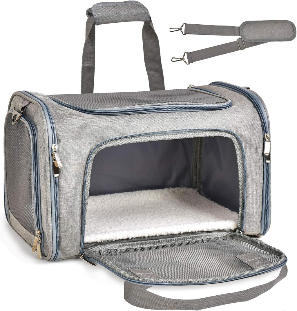 Gray pet carrier with open front door on a white background