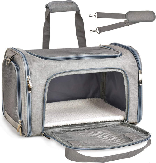 Gray pet carrier with open front door on a white background