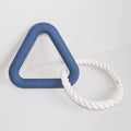 Blue triangular ring and white rope ring on a light gray background