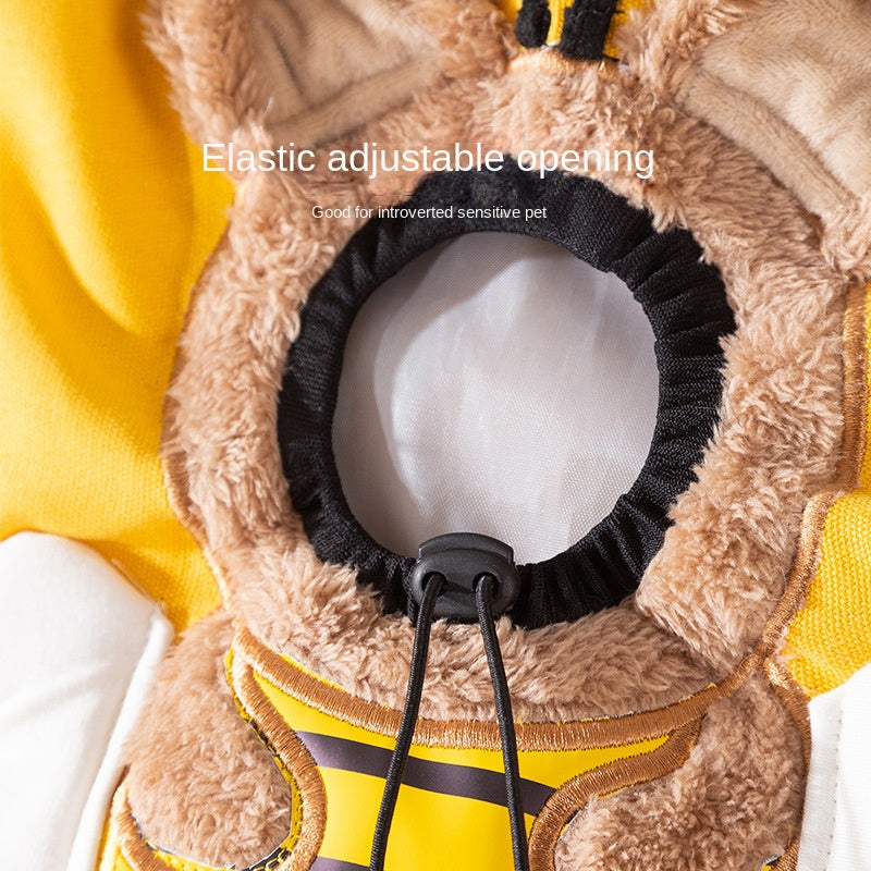 Close-up of a plush pet coat with an elastic adjustable opening on a yellow background.