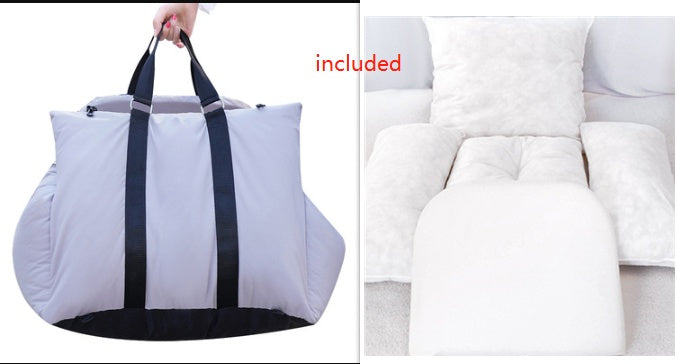 Foldable travel bag with black straps on a white background, next to a white couch.