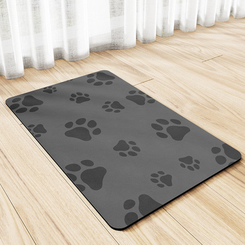 Gray mat with black paw prints on a wooden floor